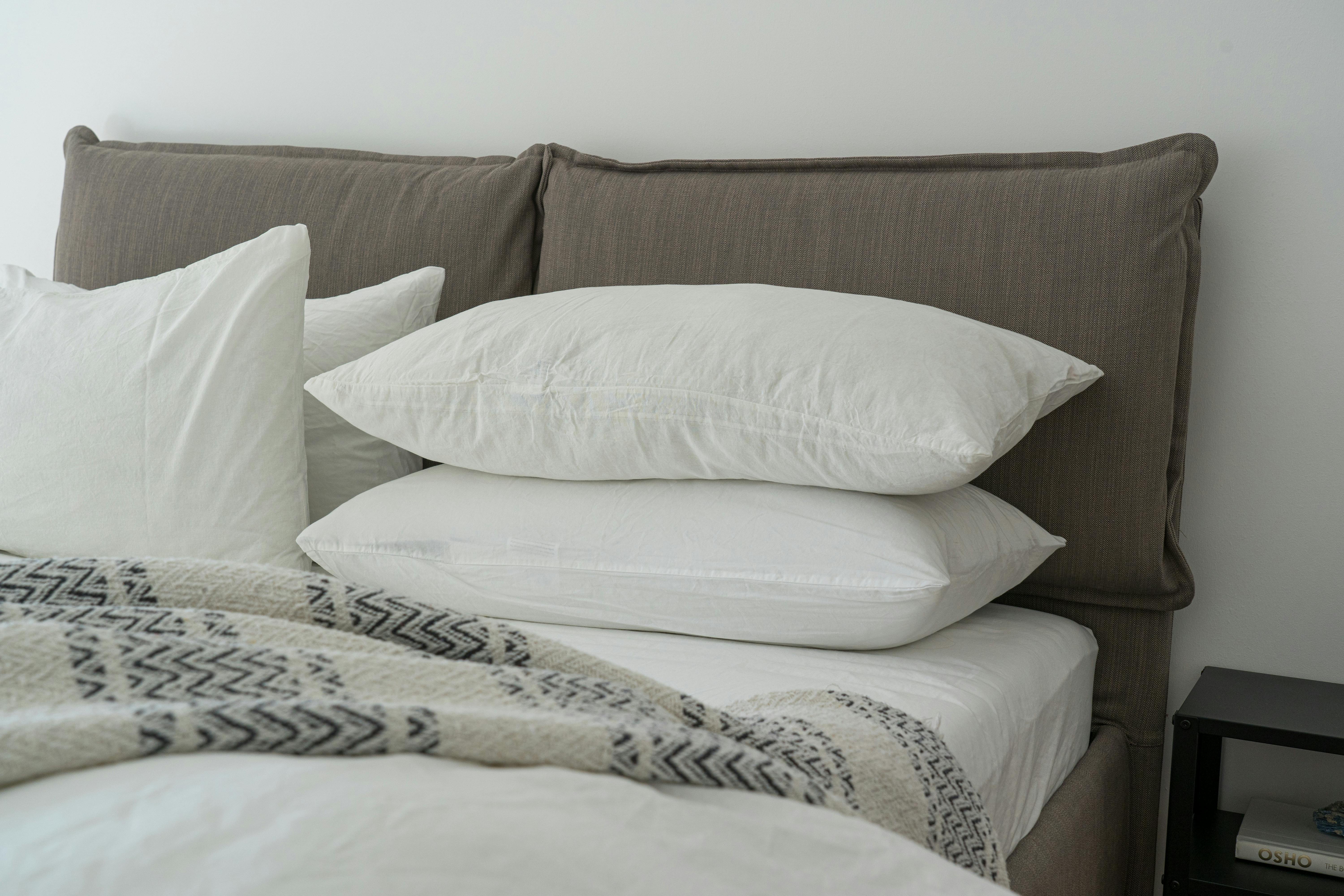 Freshly cleaned bed sheets and pillows on a bed